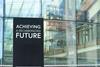 Achieving a decarbonised future on a city-center sign in front of a modern office building